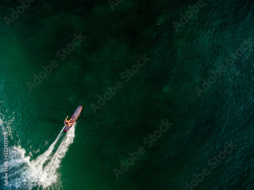 lonely surfergirl longboard green ocean standup canggu bali batubulong