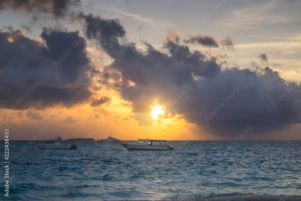 Naklejka premium Boats on a Calm Sea at Beautiful Sunset