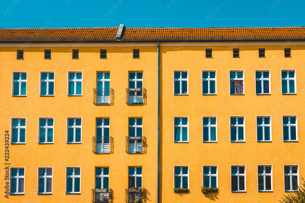 Fototapeta premium orange facade with small blue copy space on the top