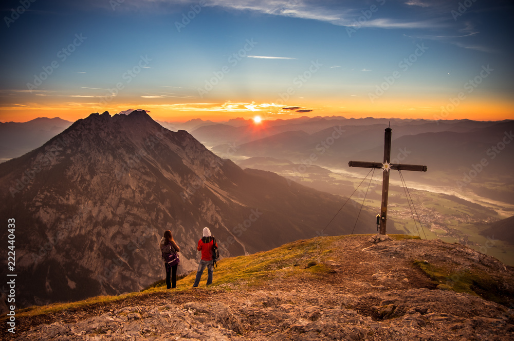 a couple enjoy the Sunset from the Mountain Stoderzinken in Austria