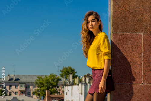 Sunny fashion portrait of a young girl against the sky © Anastasia