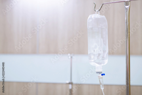 Iv saline bag infusion set and bottle on a pole. fluid intravenous drop saline drip slow hospital room or clinic. medical concept,treatment emergency shock. injection drug infusion care chemotherapy
