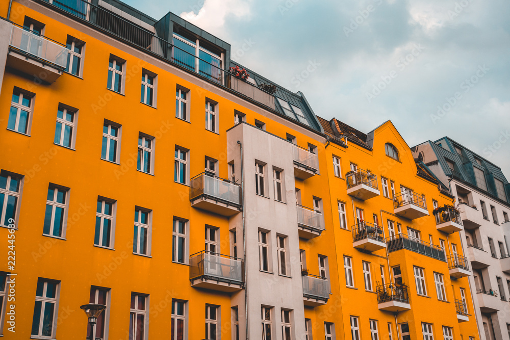 orange and white building on darken, cloudy background