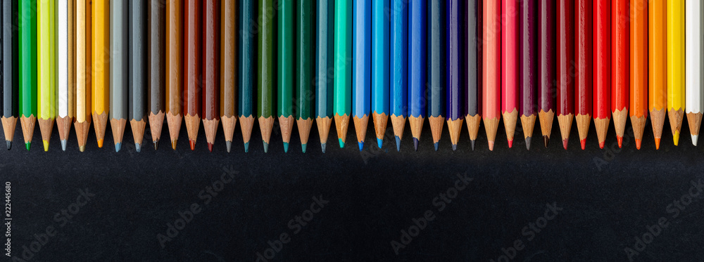 Colored pencils texture. Foreground. All the range of colors of the  rainbow. Start of school Beautiful wallpaper. Isolated on black background.  Stock Photo | Adobe Stock