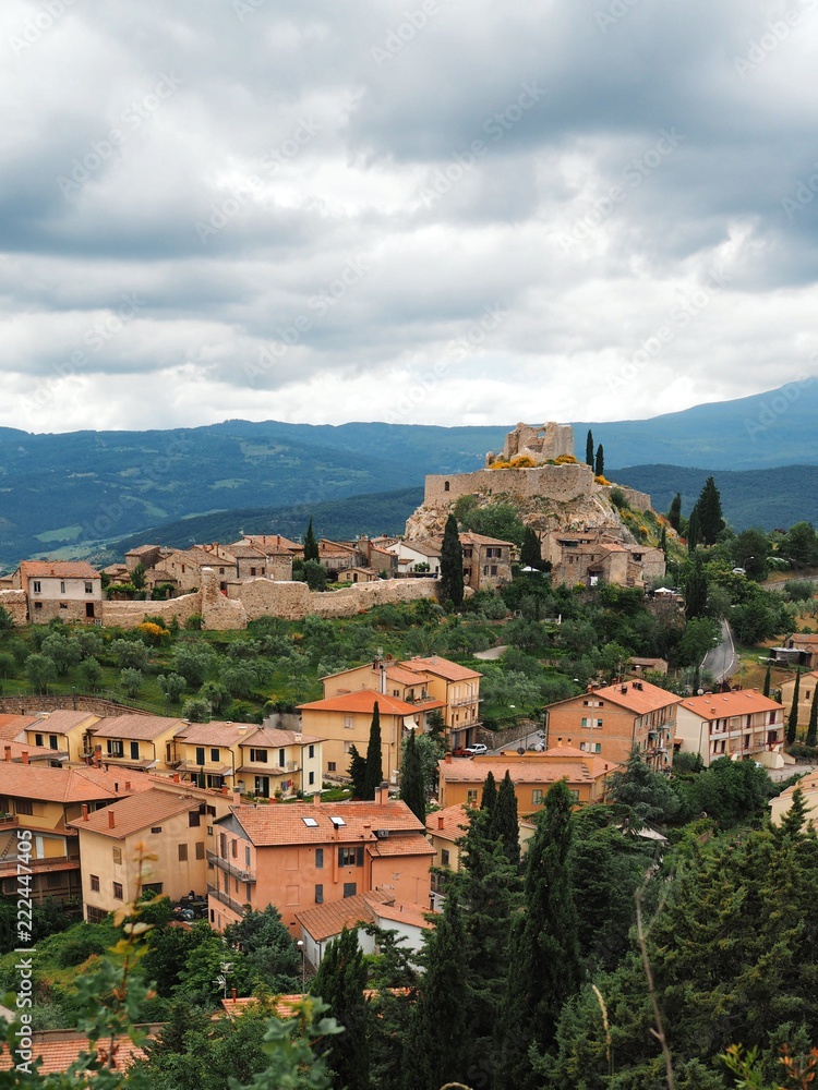 Panorama of the field and a small town, a fortress in Tuscany, photo taken from a hill