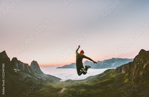 Jumping man in mountains vacations outdoor Travel Lifestyle adventure concept active success motivation and fun euphoria emotions photo