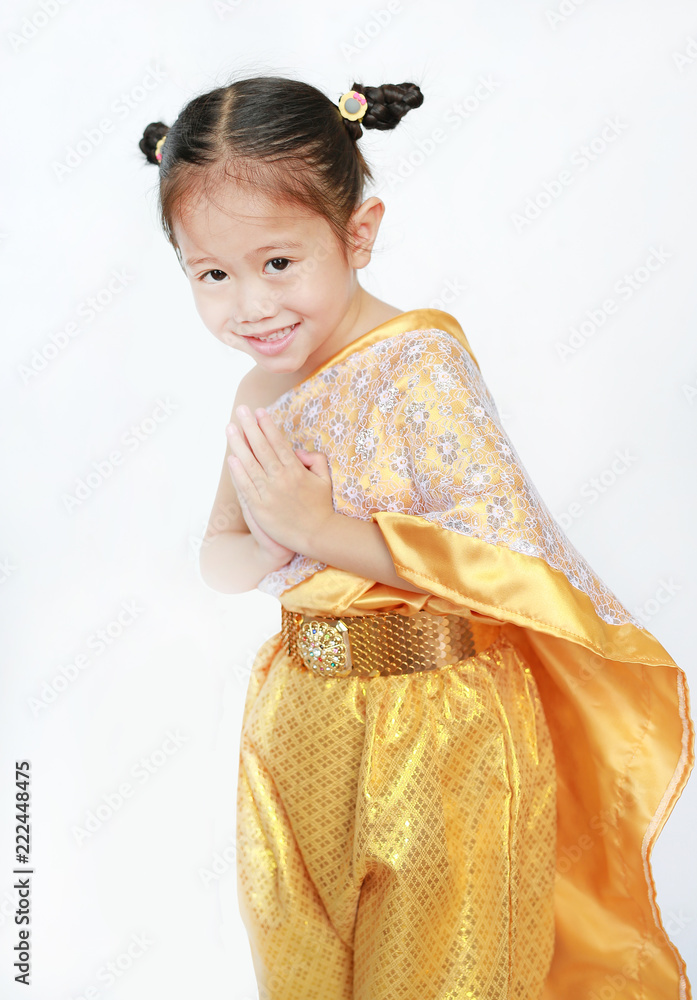 Portrait of asian child girl in traditional thai dress praying isolated on white background.