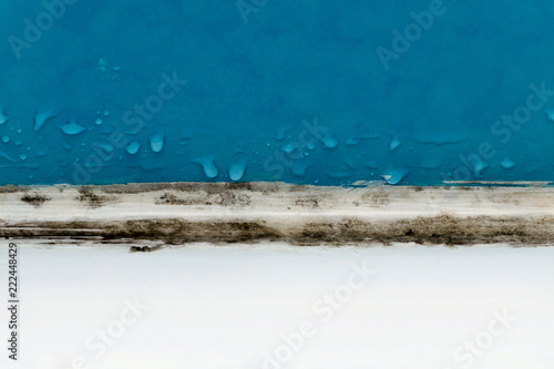 moldy bathroom with water drops on blue tile closeup photo