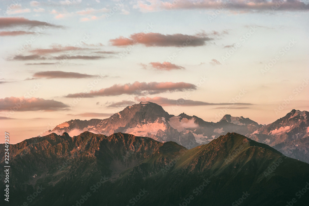 Sunset rocky mountains peaks range and clouds Landscape travel destinations wild nature tranquil scenic aerial view .