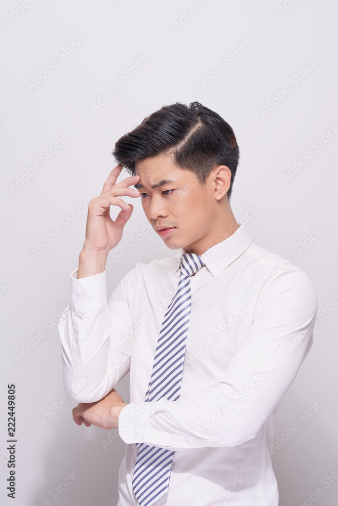 Young business man looking down isolated on white background Young business man looking down isolated on white background