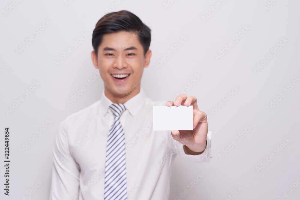 Young Man Holding Blank Visiting Card On white Background Young Man Holding Blank Visiting Card On white Background