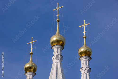 Part of the church with golden crosses on golden domes photo