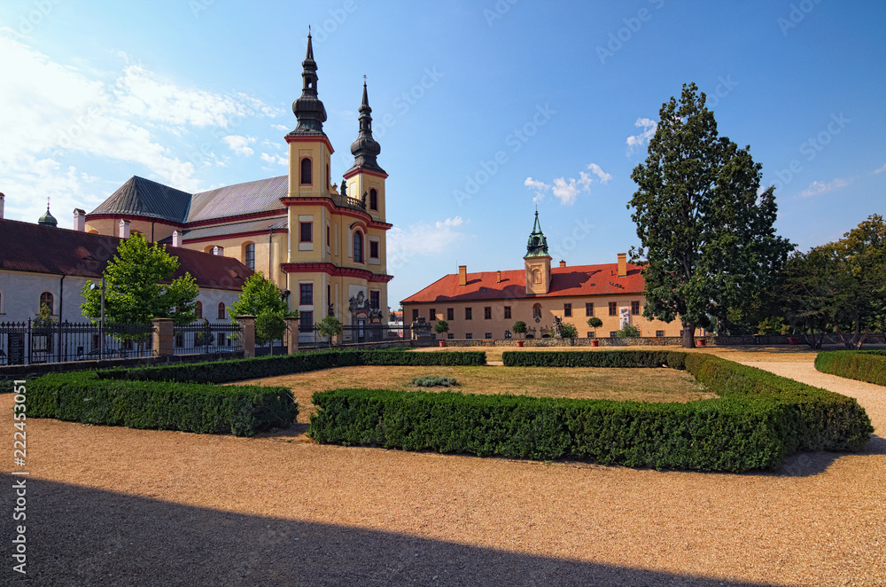 Piarist Church of the Discovery is baroque church was built 1714 and 1725 by Italian architect Giovanni Battista Alliprandi. View from the park in the Castle Litomysl by sunny day. Czech Republic