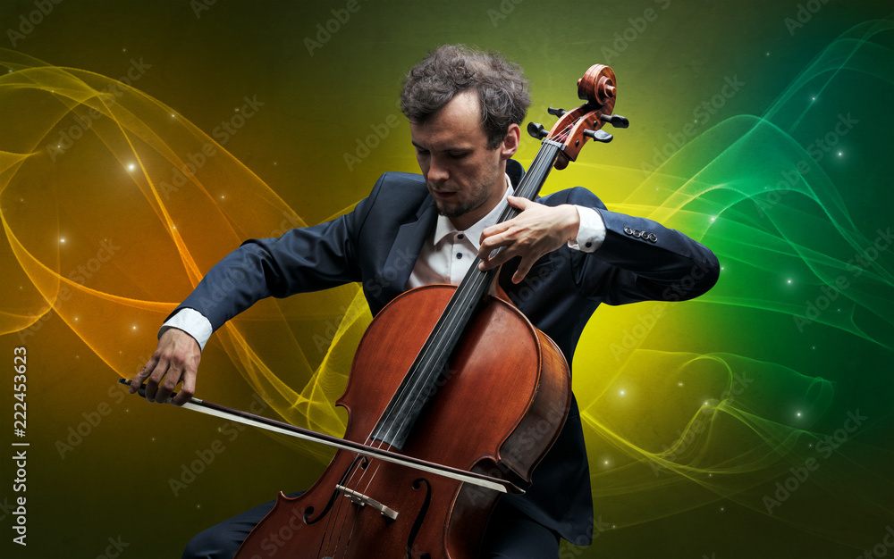 Fototapeta premium Serious classical cellist with fabled sparkling wallpaper