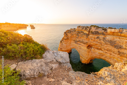 Heart shaped arch rock on Ocean, Algarve beach and coastline. Portugal