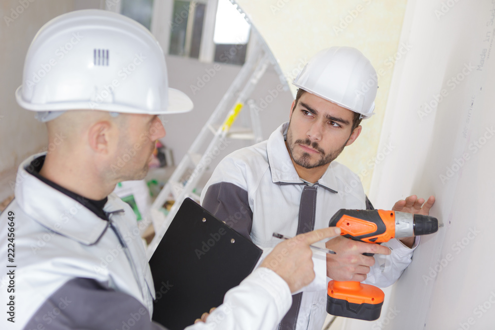 man drilling the wall with drill perforator man drilling the wall with drill perforator
