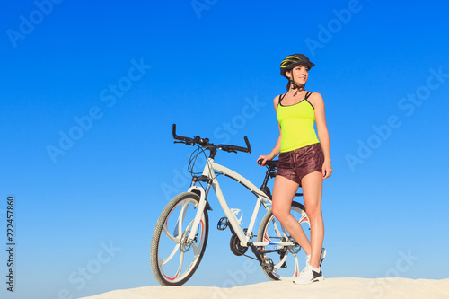 Young beautiful woman with a sport bike  soft focus background