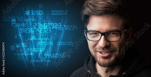 Portrait of a young businessman with blue numbers next to him on a dark background