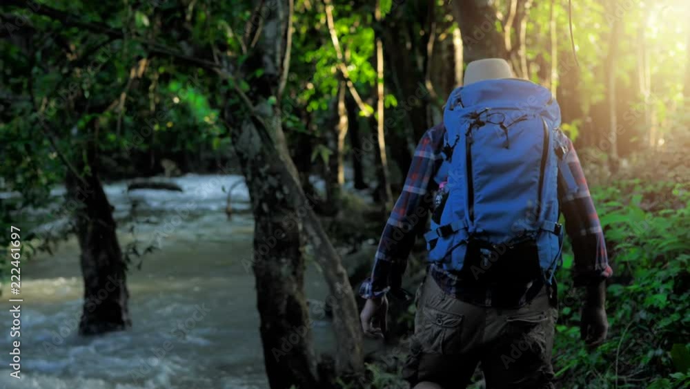 Adventurers Asian men. enjoying view sunset in beautiful forest landscape. Travel Lifestyle concept vacations into the wild wearing cozy shirt,hat with backpack. video 4k Slow motion Adventurers Asian men. enjoying view sunset in beautiful forest landscape. Travel Lifestyle concept vacations into the wild wearing cozy shirt,hat with backpack. video 4k Slow motion
