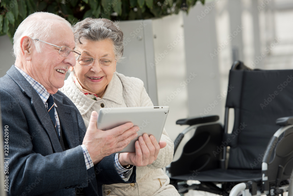old couple looking camera with tablet pc in their hands old couple looking camera with tablet pc in their hands