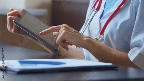 Doctor working on a digital tablet with copy space