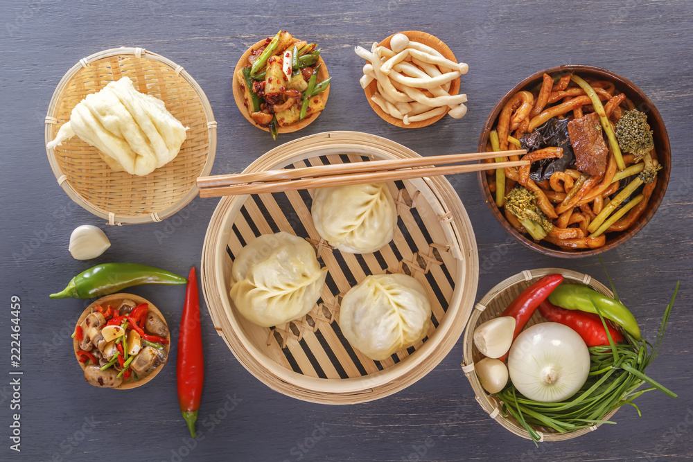 Traditional snacks of Chinese cuisine dim sum - dumplings, spicy salads, vegetables, noodles, steam bread. Top view.