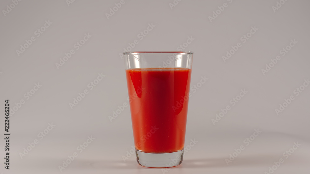 Full glass with an tomato juice on a white background Full glass with an tomato juice on a white background