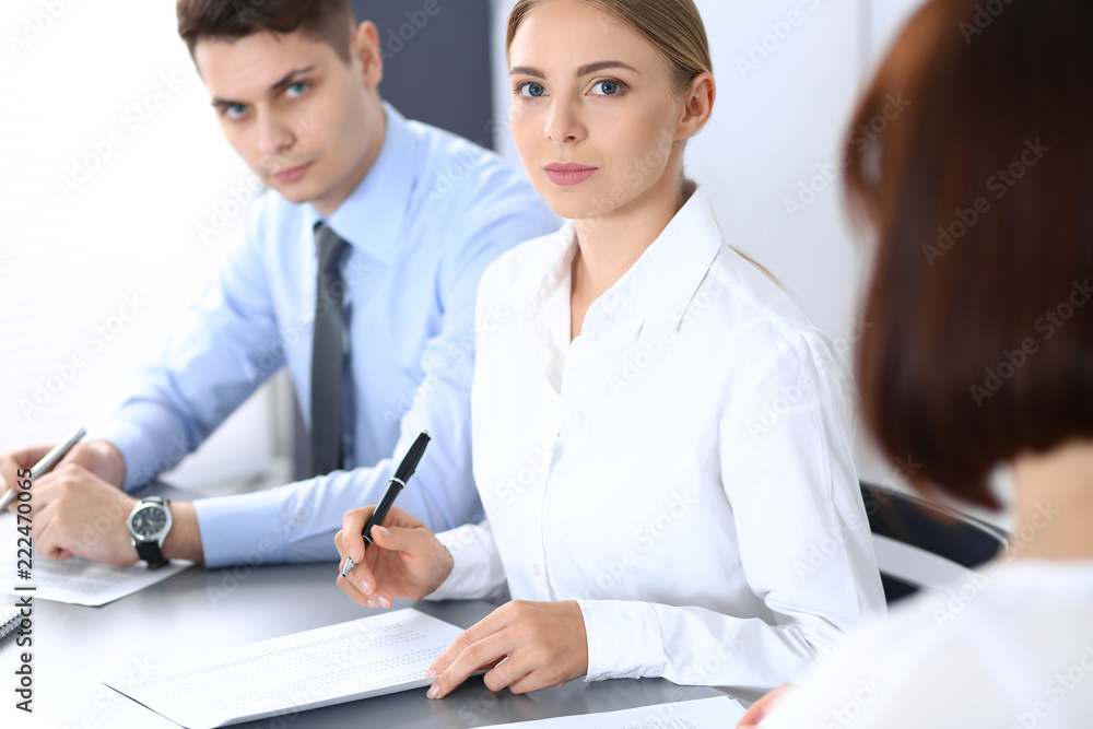 Group of business people or lawyers discussing terms of transaction in office. Meeting and teamwork concept Group of business people or lawyers discussing terms of transaction in office. Meeting and teamwork concept