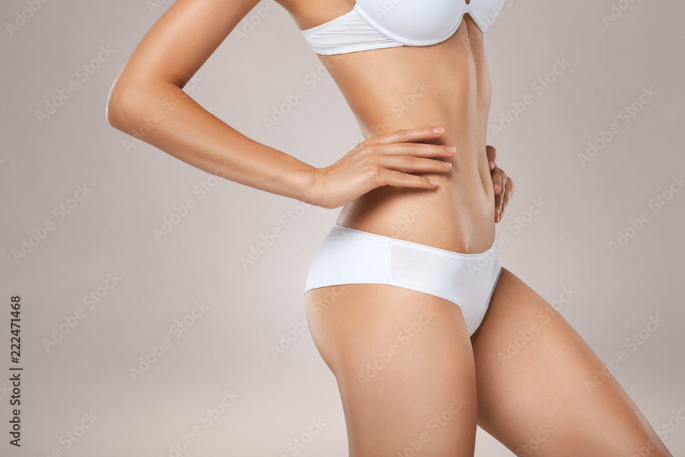 Unrecognizable slim tanned woman body in underwear - obrazy, fototapety, plakaty 