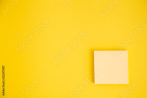 Set of yellow stick paper notes on color background.