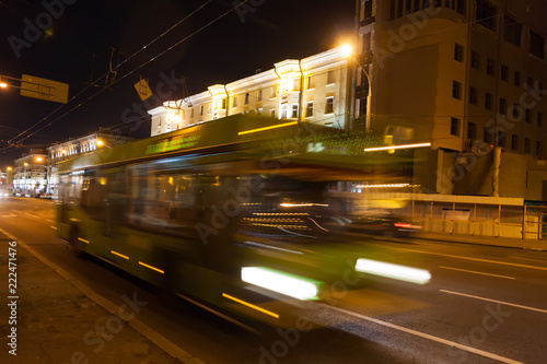 The motion of a blurred bus in the street in the evening.