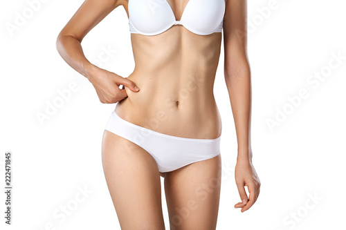 Beautiful woman in underwear testing fat layer on waist. Stock Photo by  ©ufabizphoto 235225360