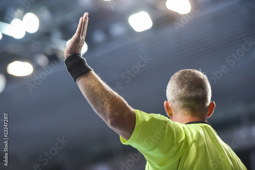 handball referee with raice hand