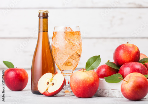 Slika na platnu Bottle and glass of homemade organic apple cider with fresh apples in box on woo
