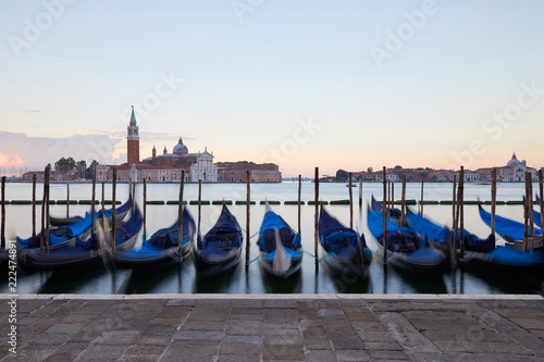 Gondolas movements and canal in Venice before sunset, Italy © andersphoto