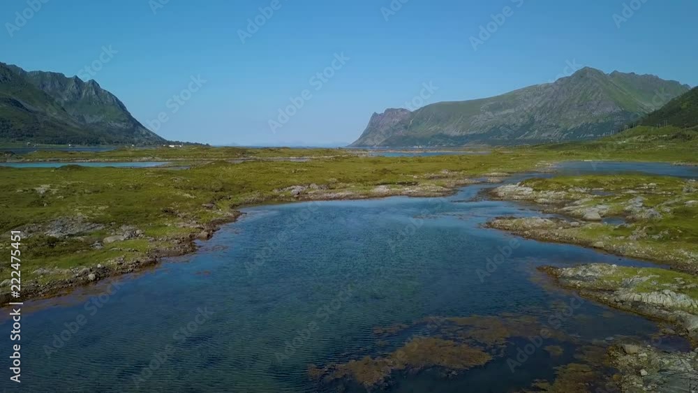 Flight over the archipelago of islands and sea straits with clear water. Norway. The Lofoten Islands. Flight over the archipelago of islands and sea straits with clear water. Norway. The Lofoten Islands.