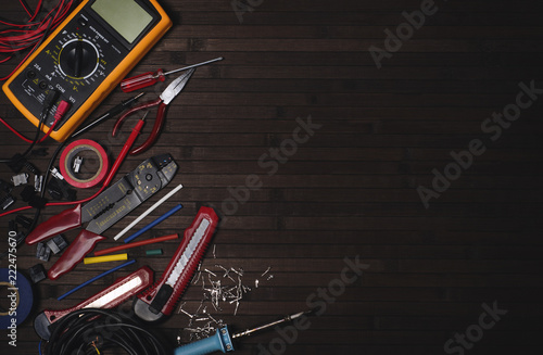 electrician tool kit on a wooden dark table