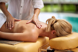 Relaxed woman receiving a massage in a spa close up.