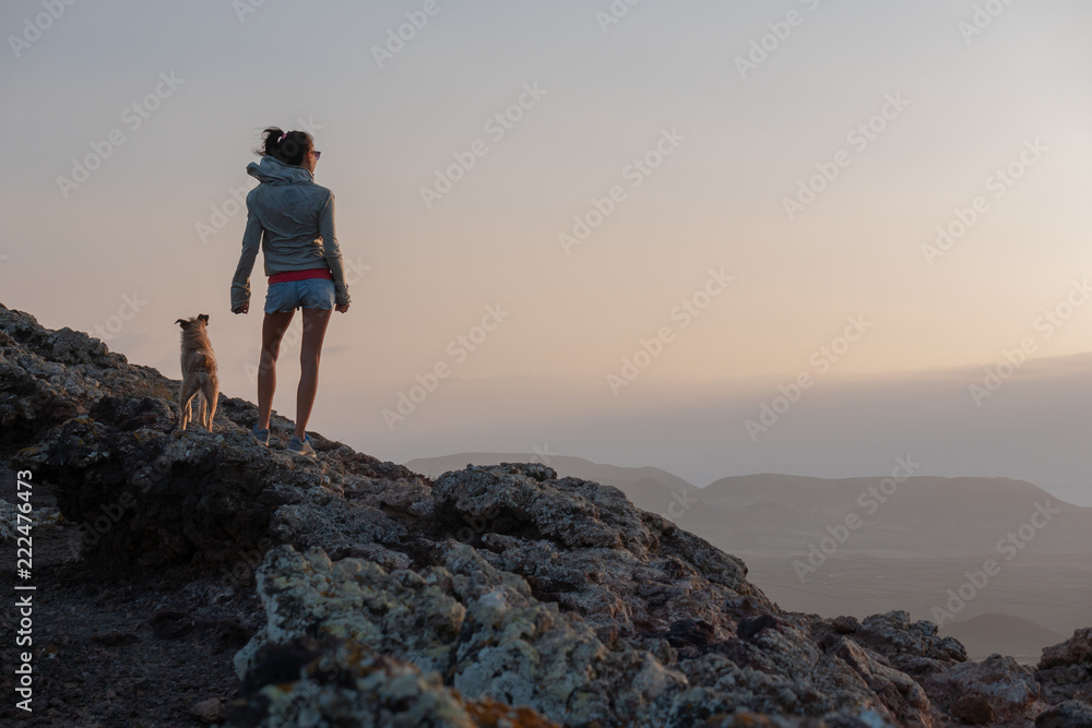 girl on the top of the volcano with her dog