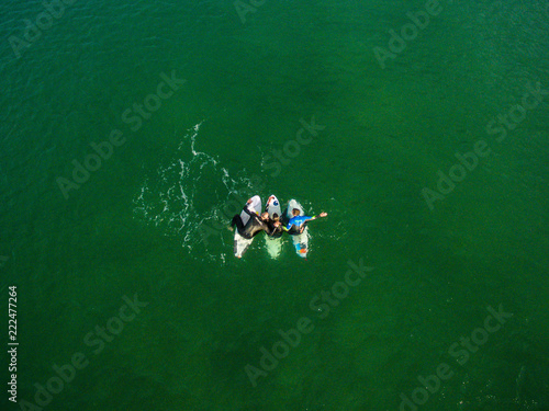 cap ferret france surfer chill green vertical drone shot aerial friends hug