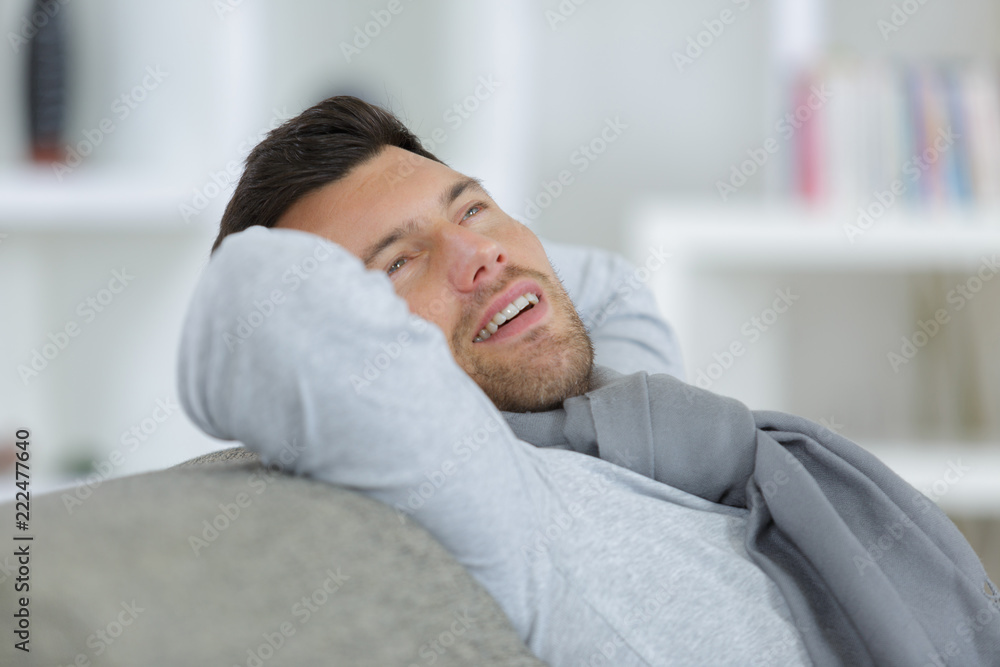 man relaxing sitting on a sofa at home man relaxing sitting on a sofa at home