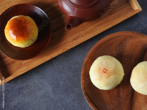 Mid-autumn festival is a traditional festival of East Asian culture and folk. Top view of yolk pastry, mung bean pastry, Oolong tea on black background. With copy space.  Flat lay.  Taiwan food.