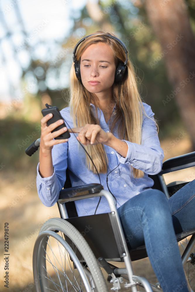 young woman on the wheelchair strolling into the woods young woman on the wheelchair strolling into the woods