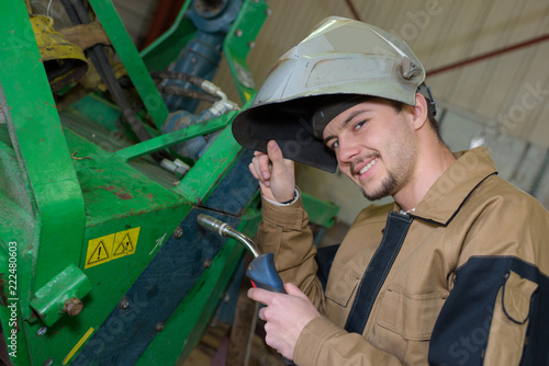 happy apprentice welder at work in the plant