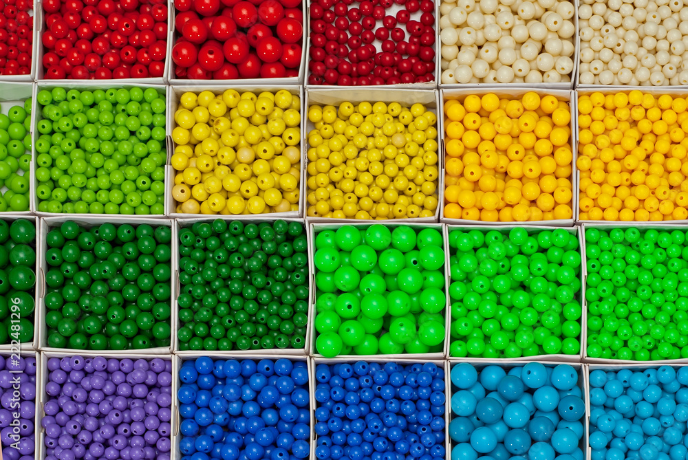 close up multi colored beads heap in box