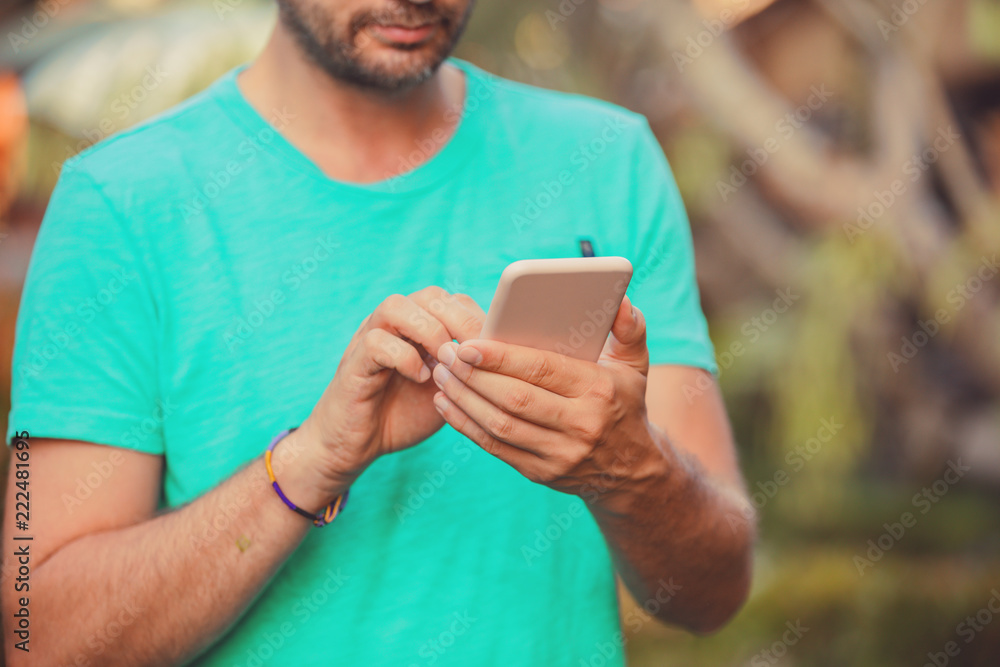 Modern man using cellphone outdoors. Modern man using cellphone outdoors.