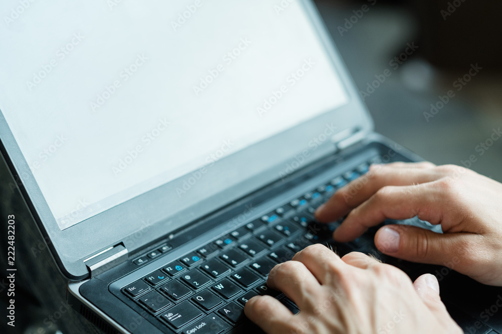 online education. remote learning on the internet. computer technology and global connection concept. man typing on laptop with empty white screen. online education. remote learning on the internet. computer technology and global connection concept. man typing on laptop with empty white screen.