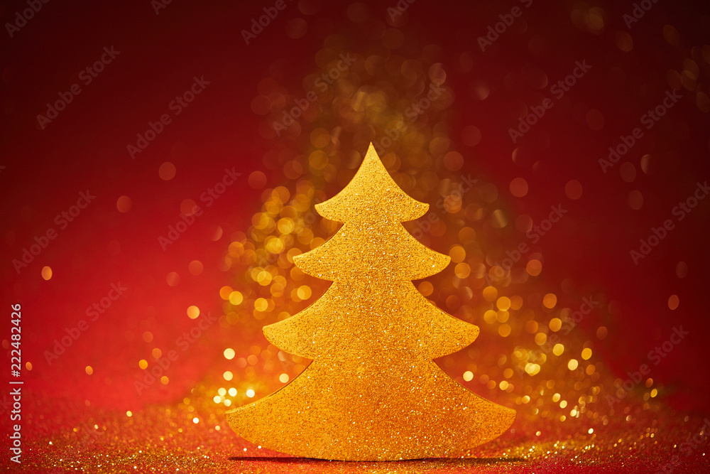 golden sparkling christmas tree for decoration on red background golden sparkling christmas tree for decoration on red background