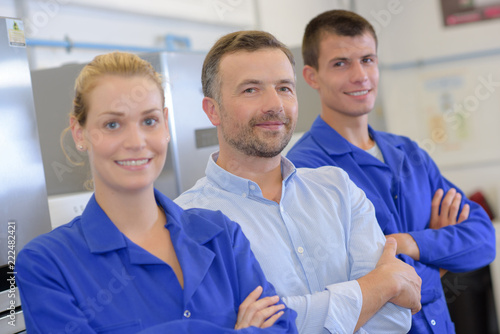 Portrait of students and teacher stood in a row