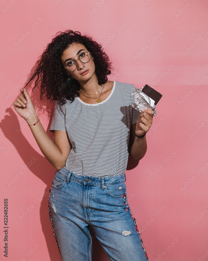 Curly haired woman holding chocolate Curly haired woman holding chocolate
